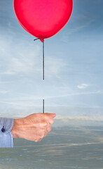 Oops. Hand with balloon on broken string. Concept.