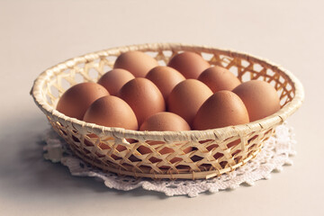 straw basket with brown eggs. 