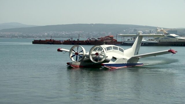 Multi-purpose ekranoplan Oriole with two huge rotating screws floats along Gelendzhik Bay, like boat. Close-up. Blurred background. Selective focus. Gelendzhik, Russia, 201