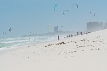 kite surfing on the beach with people taking photos of the international competition in Bloubergstrand, Cape Town, South Africa
