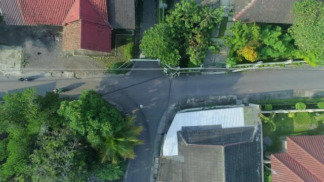 Top down view aerial footage of intersection small road in neighbourhood Yogyakarta city, Indonesia during covid19 pandemic