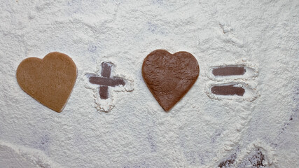 two different hearts, light and dark, made from raw cookie dough made by hand, maths