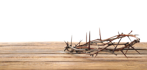 Crown of thorns on wooden table against white background, space for text. Easter attribute