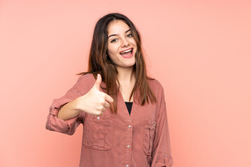 Fototapeta premium Young caucasian woman isolated on pink background with thumbs up because something good has happened