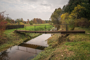 Footbridge over the Czarna river at autumn near Gora Kalwaria, Mazowieckie, Poland