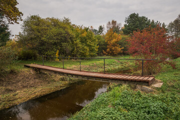 Footbridge over the Czarna river at autumn near Gora Kalwaria, Mazowieckie, Poland