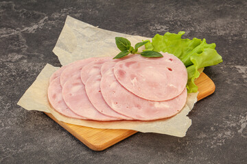 Slised ham snack over board