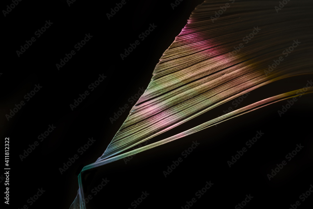 Aufkleber close up beautiful book pages in the multi color light on a night. background pattern for design. ma
