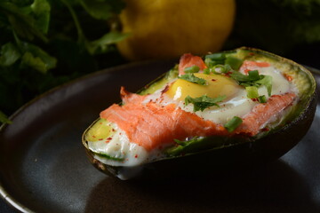 Baked smoked salmon, egg in avocado, ketogenic keto low carb diet food
