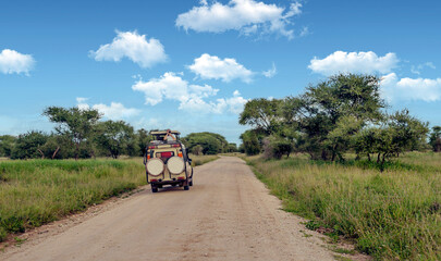 AMBOSELI, Kenya - MAY 2014. Tourist in jeep safari in the road of National Park of Kenya. They are traying see animals.