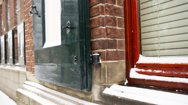Ancient window on an historic building covered with some snow at the martini kerkhof in groningen