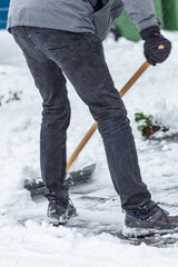 Man is clearing snow at his house after a snow storm