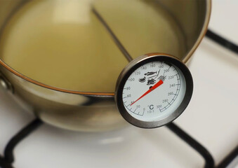 Food kitchen thermometer close up. Measuring heating liquid temperature. Cooking food & kitchen...