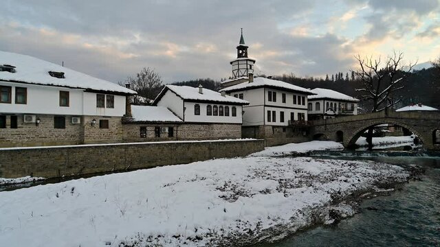 Video before sunset with old houses covered with snow in the revival architectural complex in Tryavna, Bulgaria.