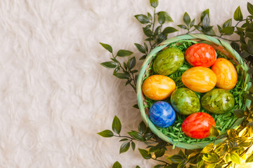 Easter card. Flat lay composition with easter eggs in a basket on white background.