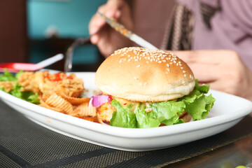 beef burger and chicken on plate on cafe table close up 