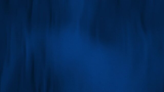 Abstract full-frame blue flag cloth with selective focus waving in the wind. Concept 3D animation loop background of colored garment with velvet satin texture as copy space backdrop and web banner.