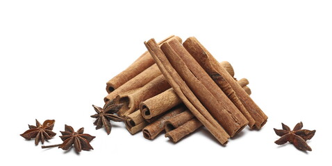 Cinnamon sticks and star anise pile isolated on white background