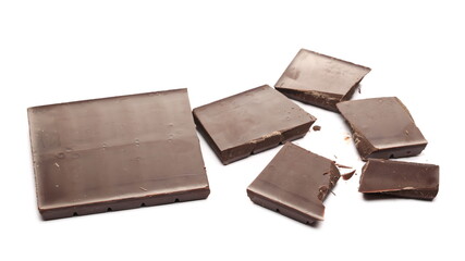 Chocolate bar pieces pile isolated on white background