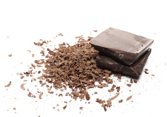 Chocolate pieces and grated flakes, shavings pile isolated on white background