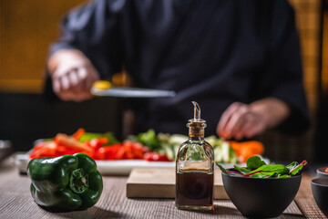 chef cutting vegetables on board