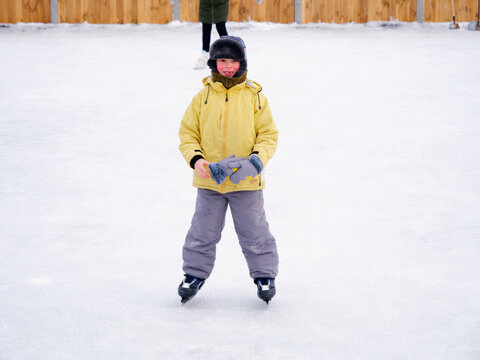 boy skating on an outdoor ice rink