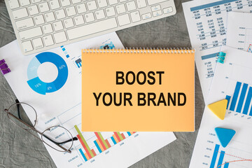 BOOST YOUR BRAND is written in a document on the office desk