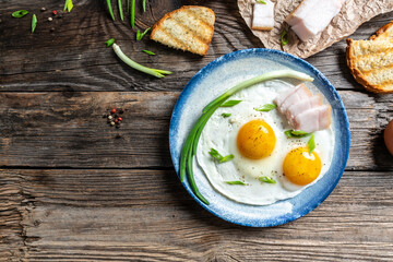 Portion of fried eggs with lard bacon. National Ukrainian or belorussian food. banner, catering menu recipe place for text, top view