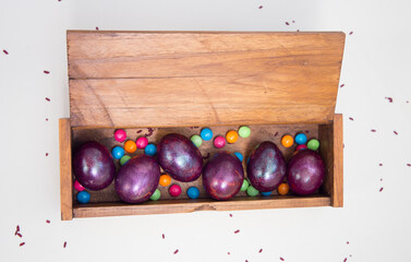 Happy Easter purple eggs in a wooden box