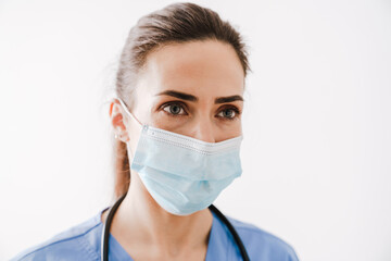 Beautiful young woman doctor in medical mask