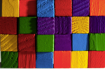 wooden colorful cubes wall close-up view