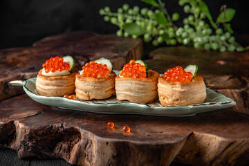 Tartlets or canapes with butter and red caviar. Gourmet food, appetizer. Delicatessen. Seafood