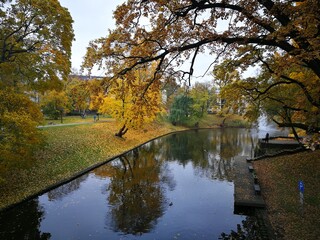 Riga canal with yellow coloured trees on an autumn day.