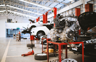 mechanic working car maintenance with soft-focus and over light in the background