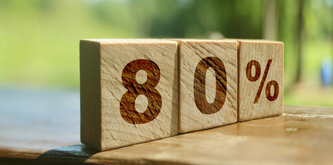 80 percent written on wooden blocks on nature landscape background. Big Sale discount marketing business concept