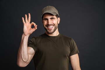 Fototapeta premium Happy masculine military man smiling and showing ok sign