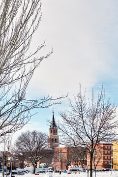 Snowy view of the Parroquia San Pedro Ad Vincula Madrid from Sierra Gorda street. Tormeta "Filomena&rdquo;. Vertical ratio