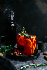 Hot mulled wine in a transparent glass on the table