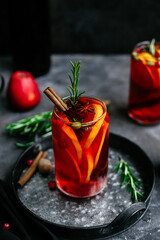 Hot mulled wine in a transparent glass on the table