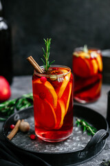 Hot mulled wine in a transparent glass on the table