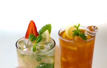 Background image with Mojito cocktail with strawberry, ice and mint