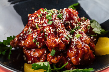 Closeup on asian marinated chicken in spicy sauce with daikon 