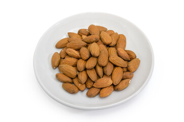 Peeled almonds  on saucer on a white background