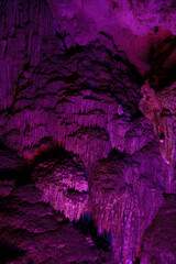 Stalactite and stalagmite formations in a limestone cave of Halong Bay,