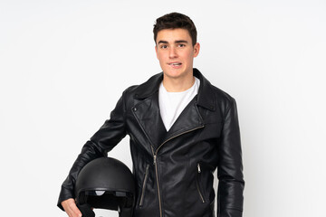 Man holding a motorcycle helmet isolated on white background having doubts and with confuse face expression