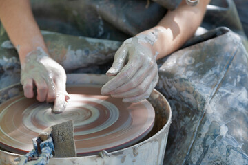 Hands of Potterwork with  pottery wheel