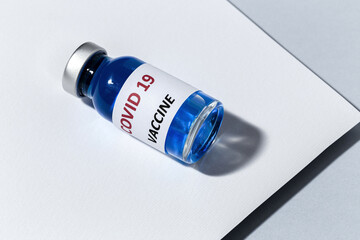 Transparent glass vials with test COVID-19 vaccine, with syringes