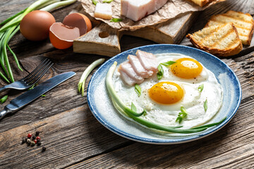 Breakfast in the morning. fried egg and lard bacon. Food recipe background. Close up