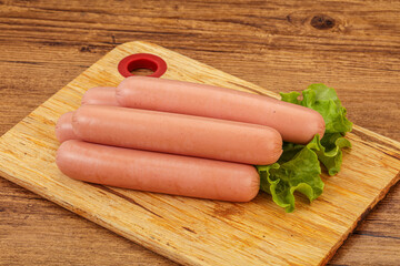 Tasty meat sausages over board