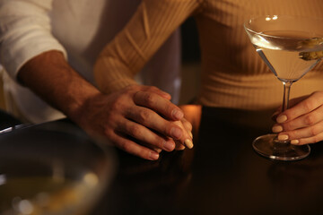 Man and woman flirting with each other in bar, closeup